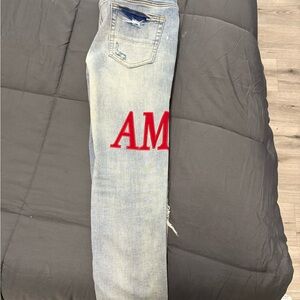 AMIRI Light Blue Skinny Jeans with Red Logo